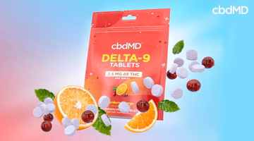 Delta-9 THC tablets pouch with orange slices, berries, mint, and dissolvable supplement tablets.